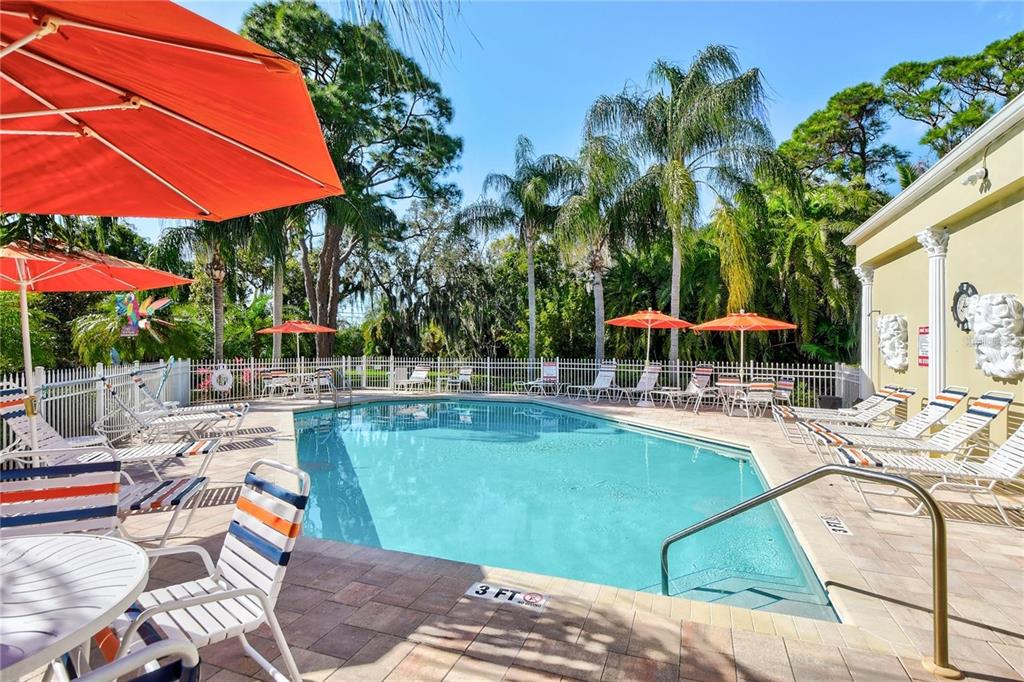 11117 Kapok Grand Circle Madeira Beach, FL 33708 - Photo 52 of 62 a view of a swimming pool with lounge chairs in patio
