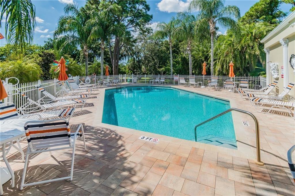 11117 Kapok Grand Circle Madeira Beach, FL 33708 - Photo 53 of 62 a view of a swimming pool with chairs