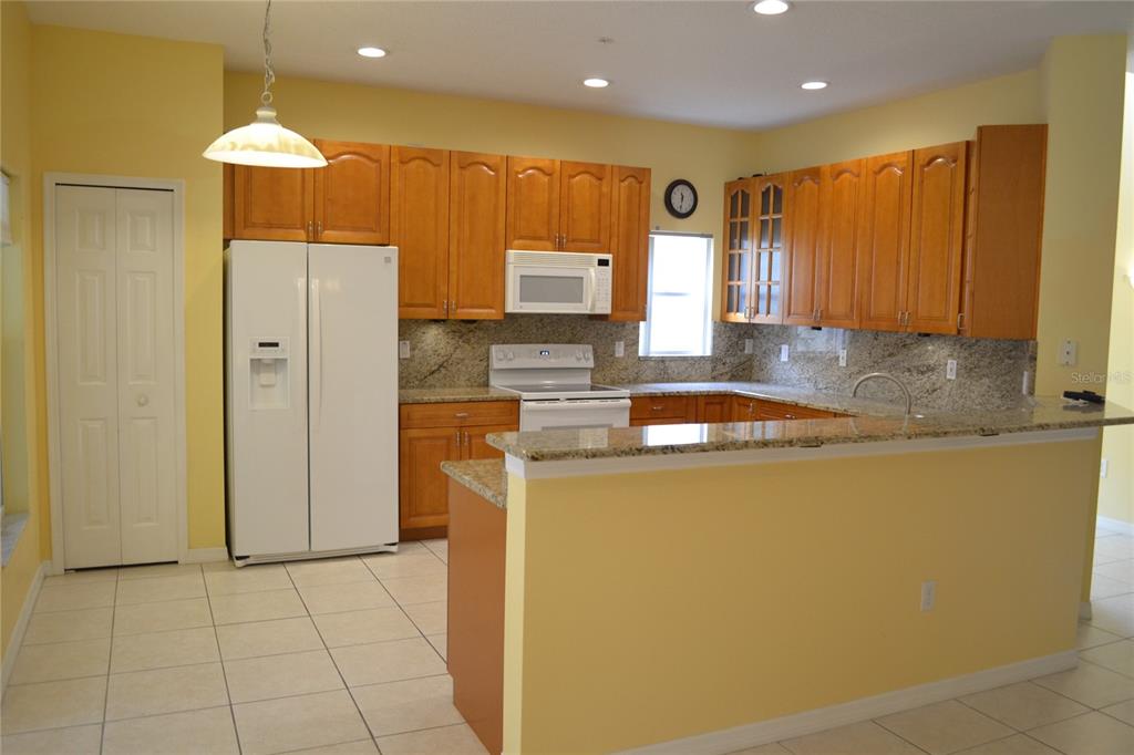 11117 Kapok Grand Circle Madeira Beach, FL 33708 - Photo 6 of 62 a kitchen with a refrigerator and a sink