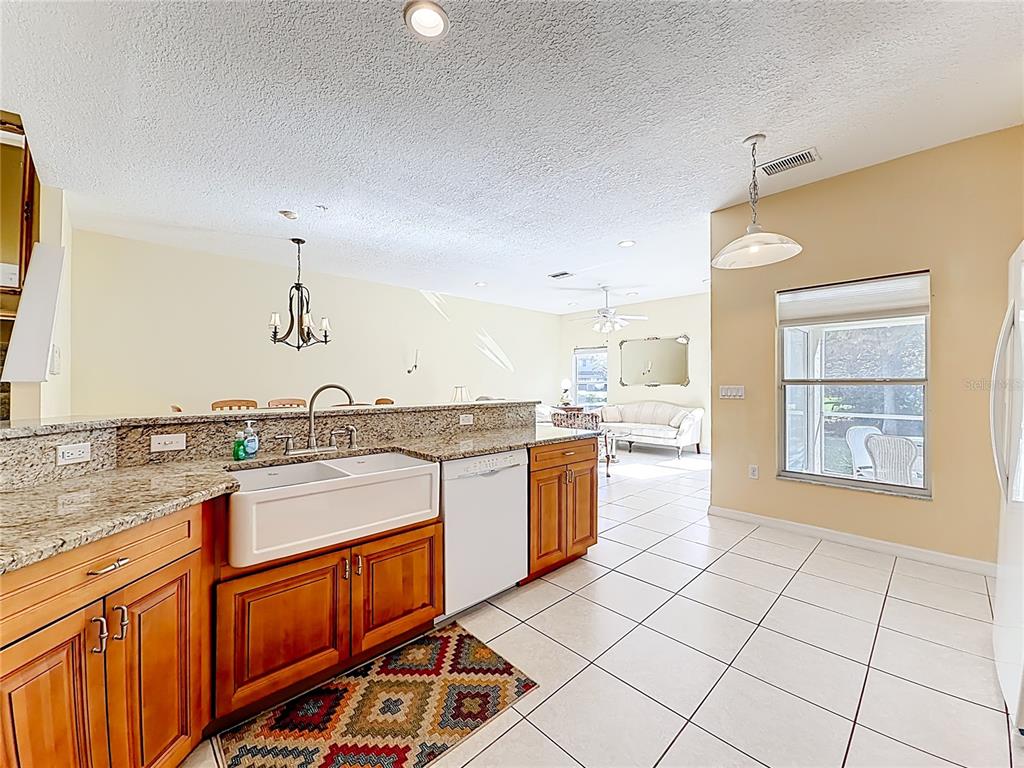 11117 Kapok Grand Circle Madeira Beach, FL 33708 - Photo 7 of 62 a kitchen with a sink stove and cabinets