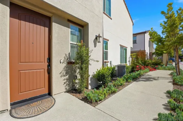 a kitchen with stainless steel appliances granite countertop a sink a stove and a living room view