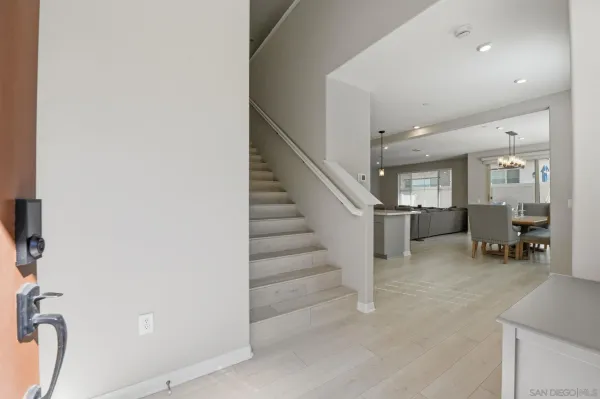 a large kitchen with kitchen island a sink a center island stainless steel appliances and a window