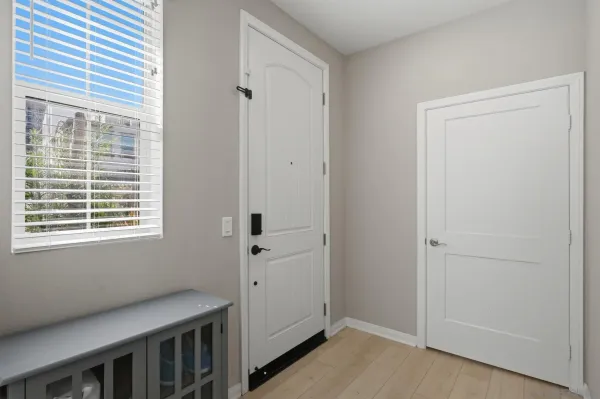 a kitchen with refrigerator a center island a stove and a sink with wooden floor