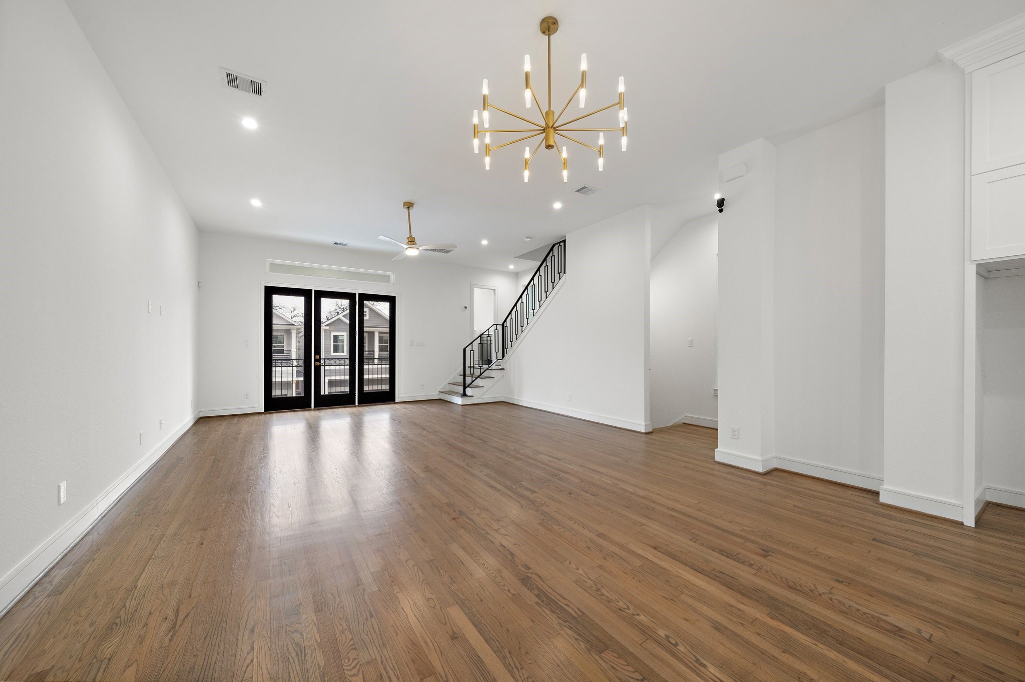 1013 East 28th Street Houston, TX 77009 - Photo 17 of 38 a view of an empty room with wooden floor and staircase