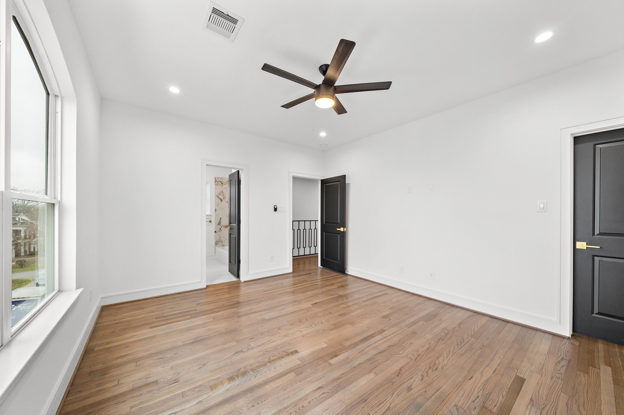 1013 East 28th Street Houston, TX 77009 - Photo 30 of 38 a view of an empty room with wooden floor and a window
