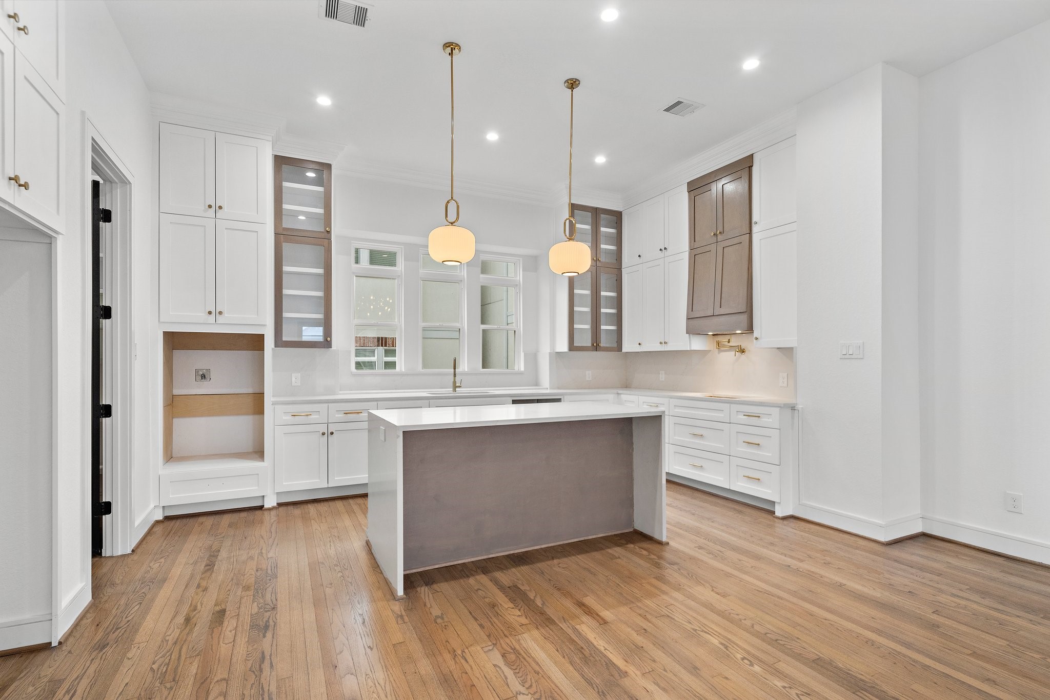 1013 East 28th Street Houston, TX 77009 - Photo 8 of 38 a large kitchen with a wooden floor and cabinets