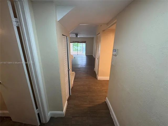 a view of hallway with wooden floor