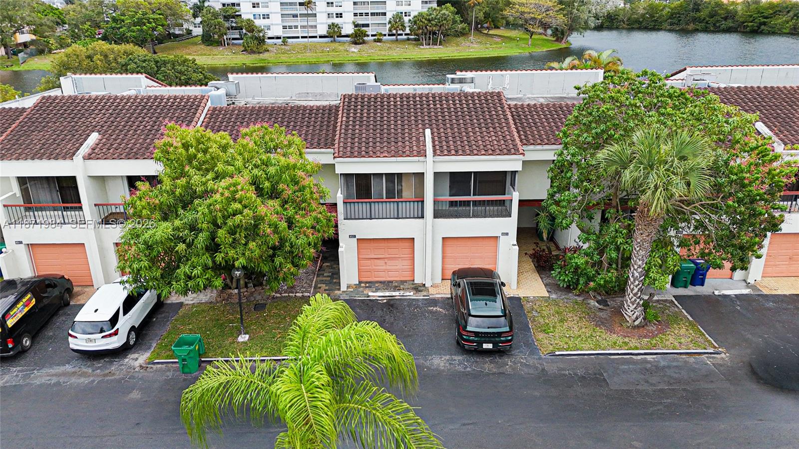 an aerial view of a house with garden space and lake view