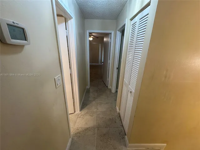 a view of a hallway with some storage and utility