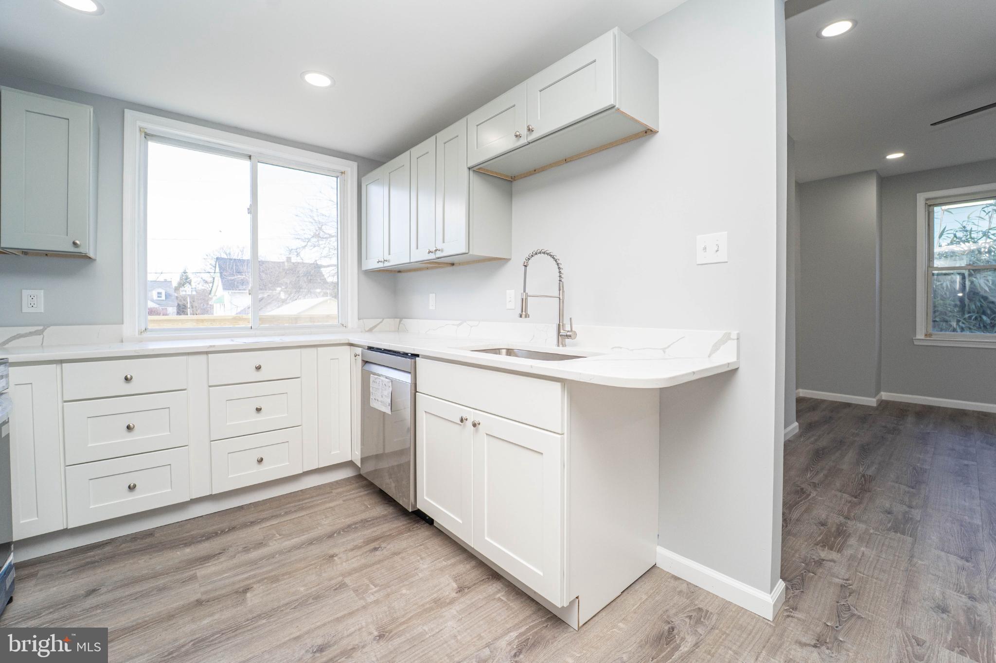 5312 Catalpha Road Baltimore, MD 21214 - Photo 18 of 59 Bright and modern kitchen with sleek finishes.