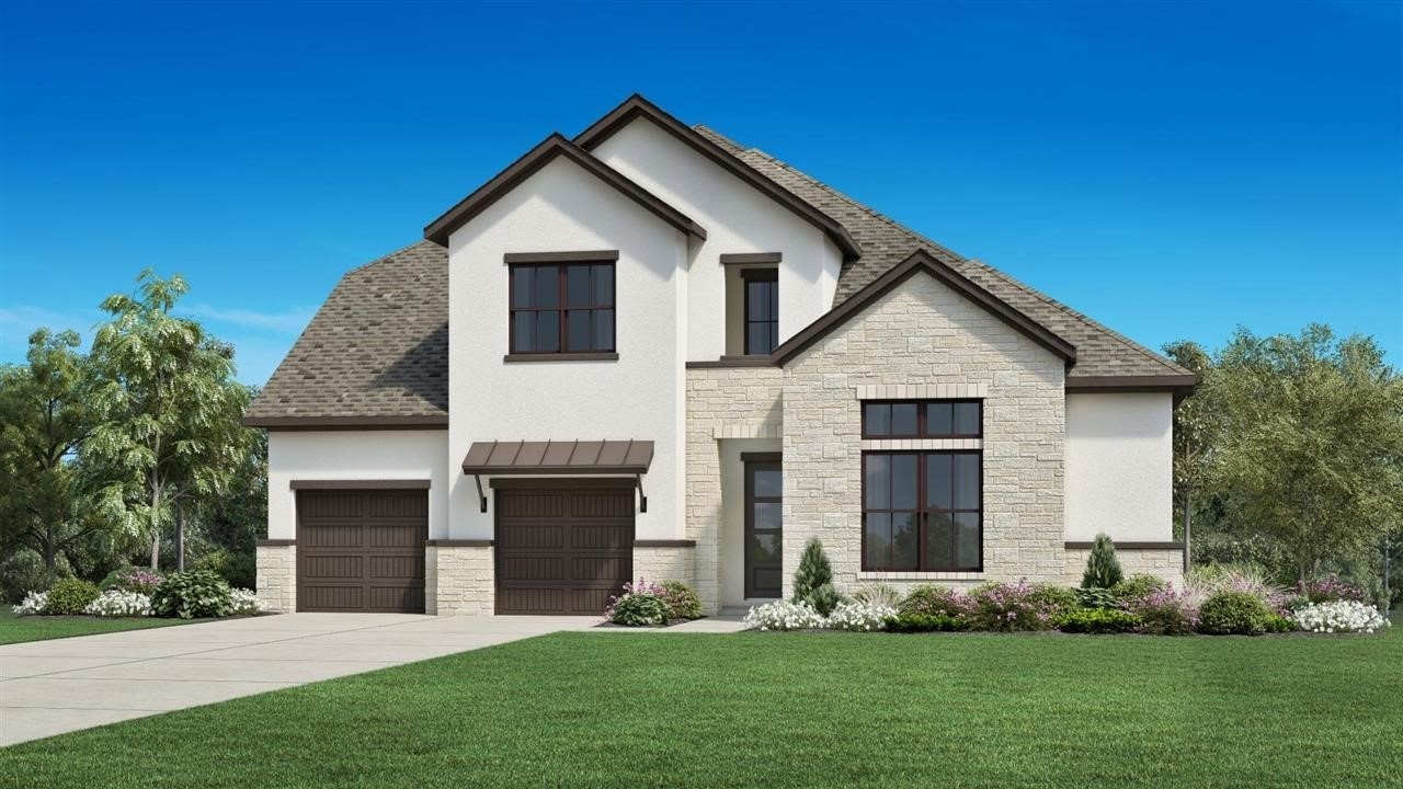 a front view of a house with a garden and yard