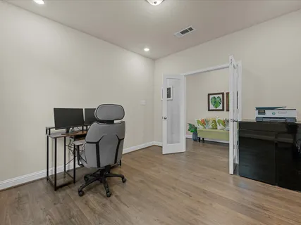 a workspace with furniture and a wooden floor