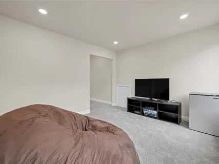 a bedroom with a bed and a flat screen tv