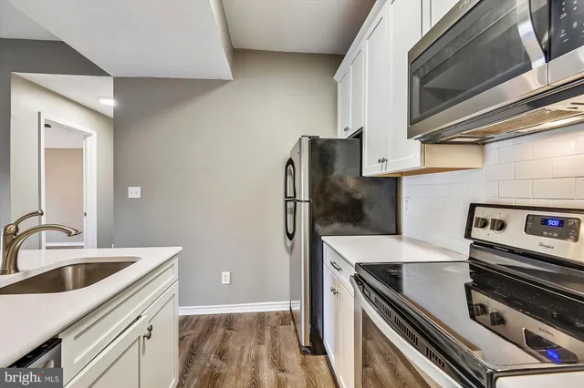 a kitchen with a sink stove and refrigerator