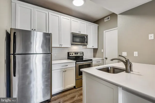 a kitchen with a refrigerator sink and microwave
