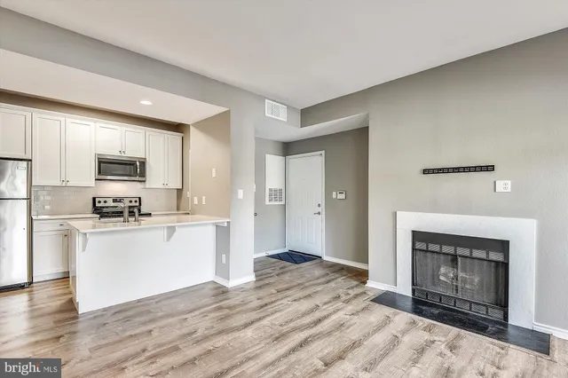 a view of kitchen with wooden floor and fireplace