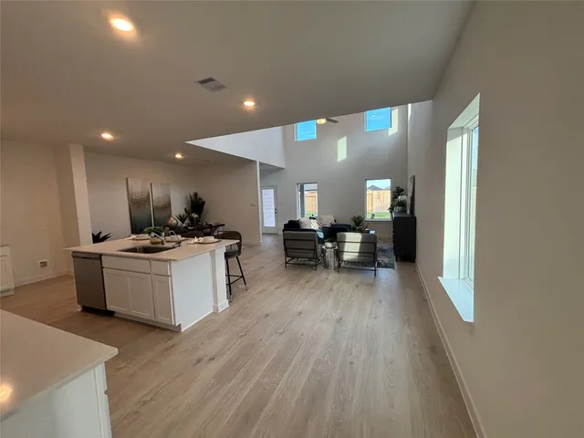 a kitchen with a sink and wooden floor