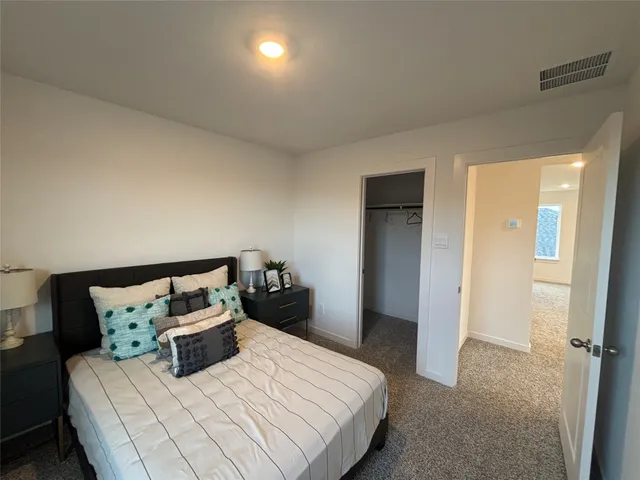 a bedroom with a bed and a night stand