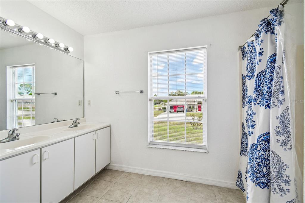 2222 Champlain Avenue Spring Hill, FL 34609 - Photo 24 of 74 a bathroom with a sink and a mirror