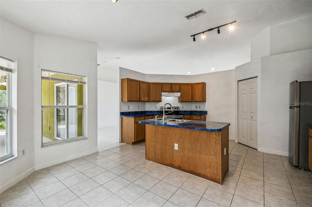 2222 Champlain Avenue Spring Hill, FL 34609 - Photo 35 of 74 a kitchen with stainless steel appliances granite countertop a refrigerator oven a sink and dishwasher