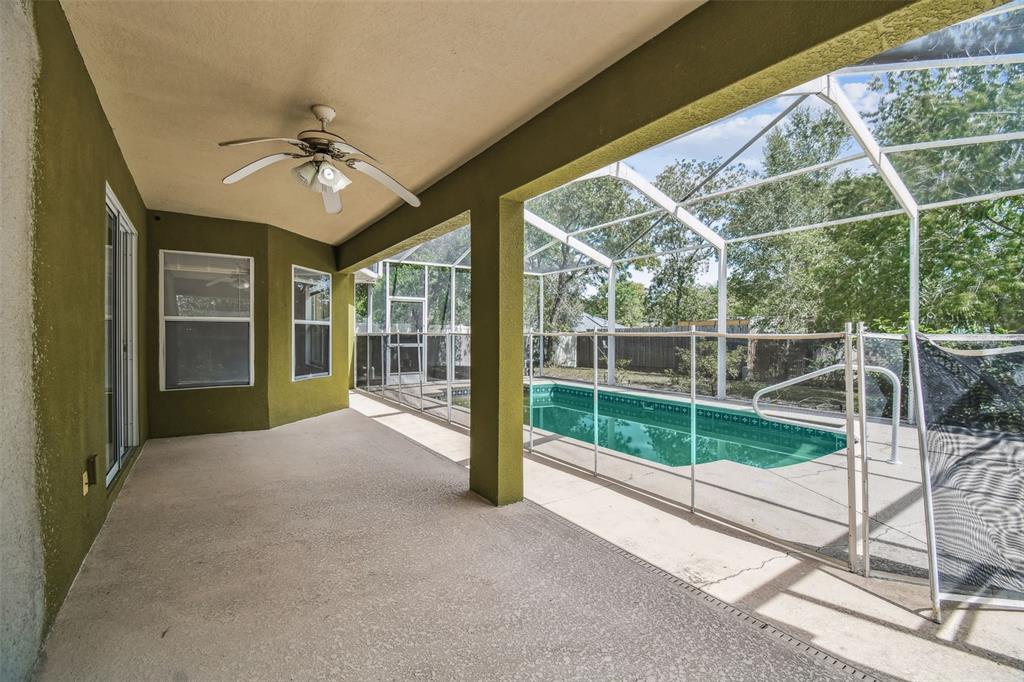 2222 Champlain Avenue Spring Hill, FL 34609 - Photo 45 of 74 a view of a livingroom with a ceiling fan and windows
