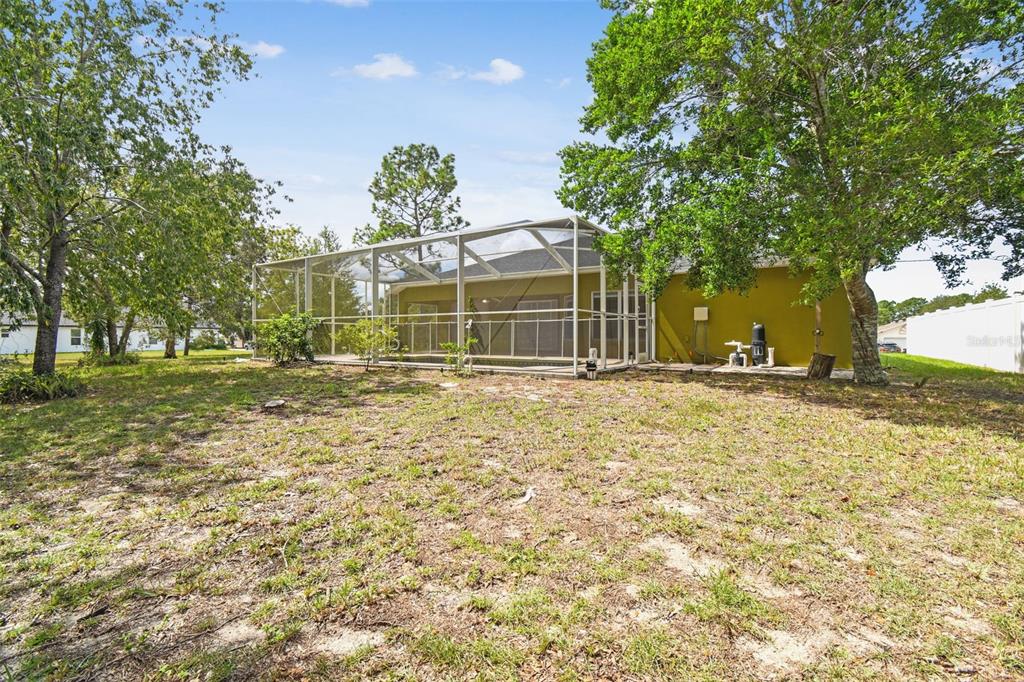 2222 Champlain Avenue Spring Hill, FL 34609 - Photo 50 of 74 a house with trees in front of it