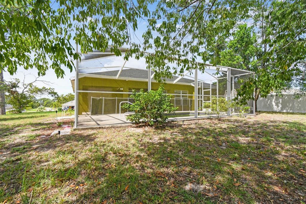 2222 Champlain Avenue Spring Hill, FL 34609 - Photo 52 of 74 a view of a house with yard and tree s
