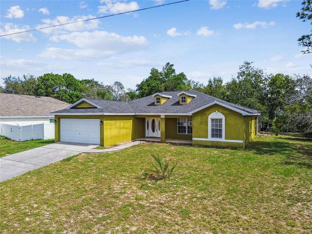 2222 Champlain Avenue Spring Hill, FL 34609 - Photo 56 of 74 a front view of house with yard and green space