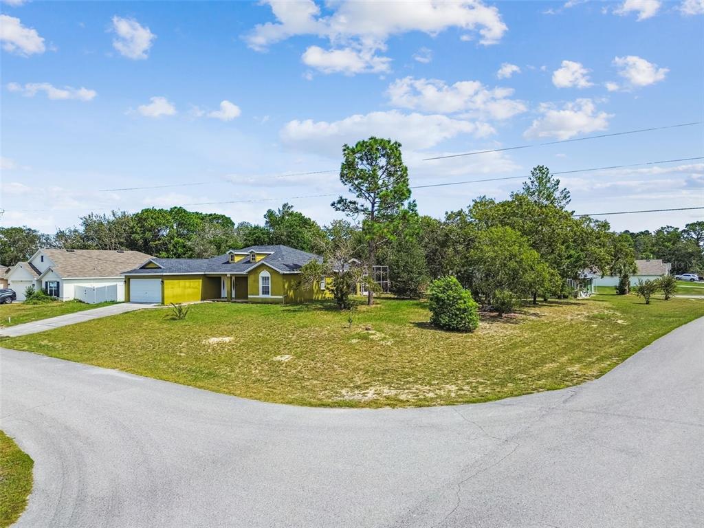 2222 Champlain Avenue Spring Hill, FL 34609 - Photo 57 of 74 a view of a house with a swimming pool and a yard