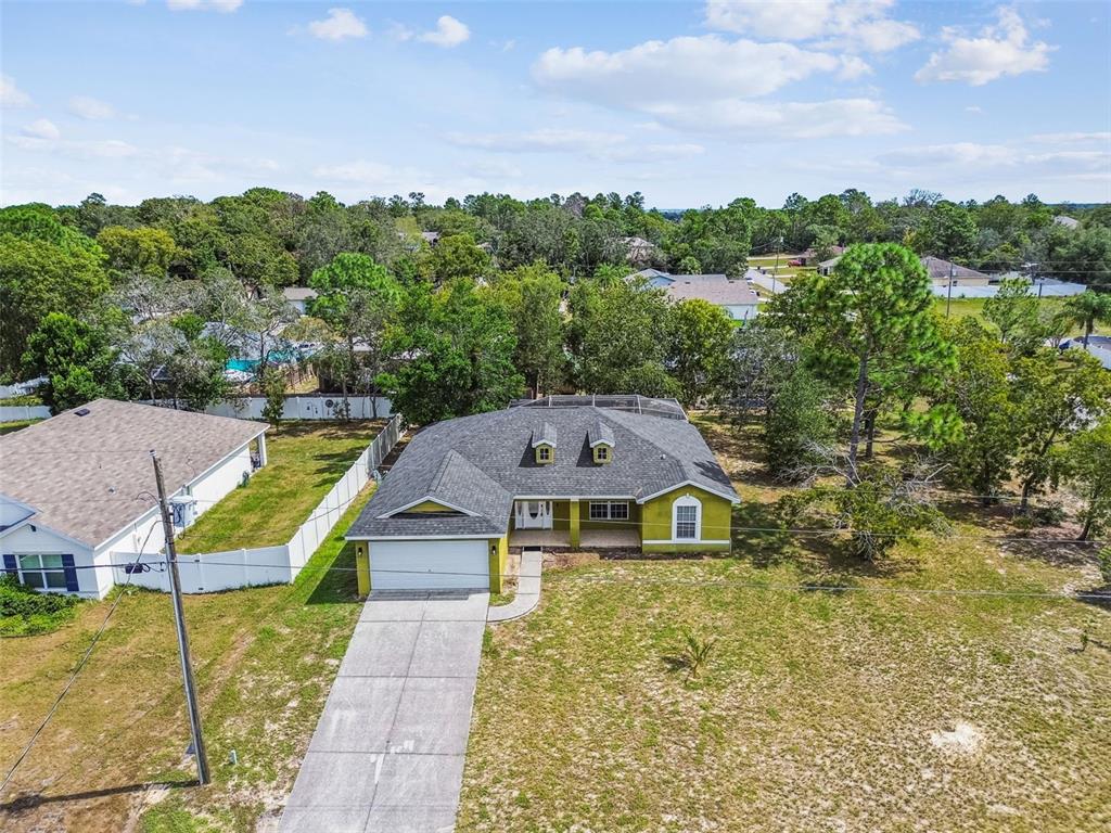 2222 Champlain Avenue Spring Hill, FL 34609 - Photo 59 of 74 an aerial view of a house with swimming pool