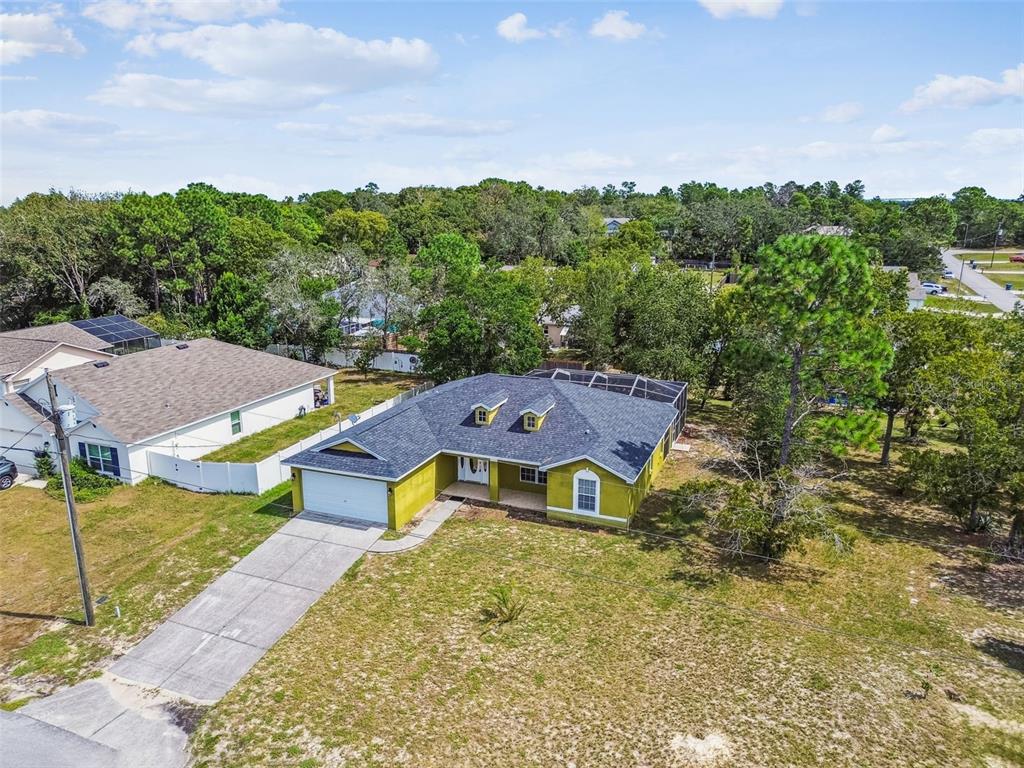 2222 Champlain Avenue Spring Hill, FL 34609 - Photo 60 of 74 an aerial view of a house with swimming pool and garden