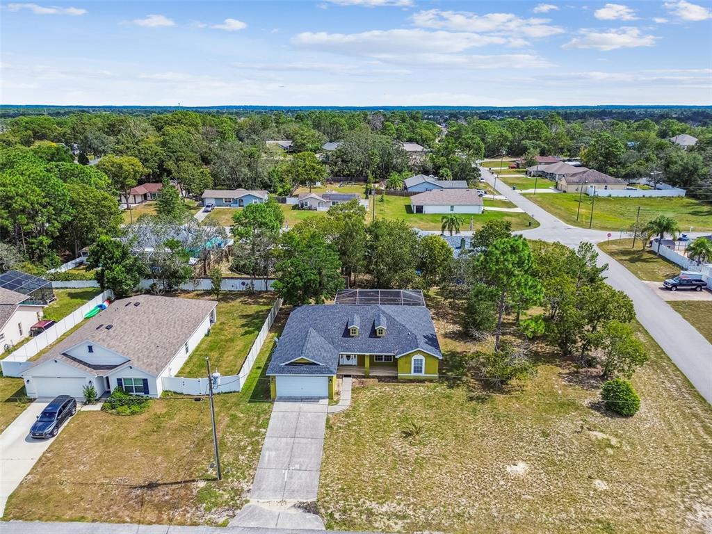 2222 Champlain Avenue Spring Hill, FL 34609 - Photo 63 of 74 an aerial view of residential houses with outdoor space and swimming pool