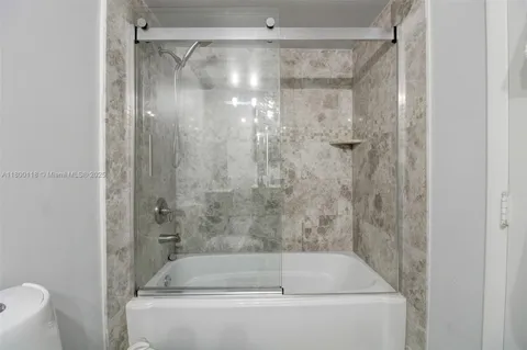 a bathroom with a shower and a bath tub
