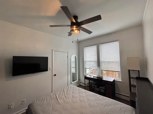 a bedroom with a bed and a mirror