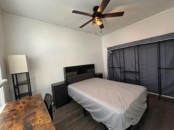 a bedroom with furniture and a window