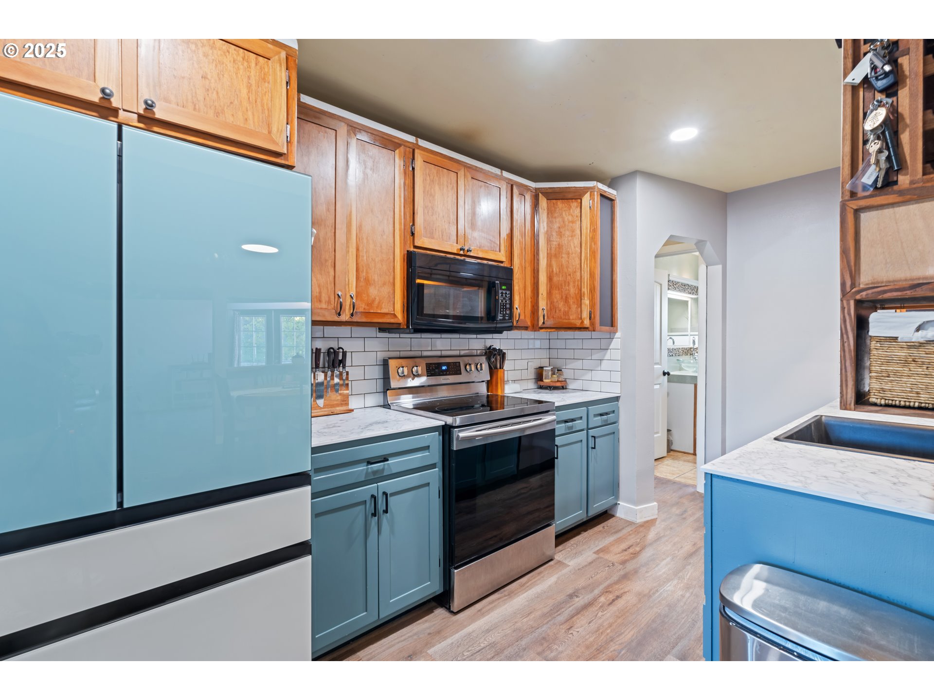 1416 East 14th Street The Dalles, OR 97058 - Photo 13 of 27 a kitchen with stainless steel appliances granite countertop a stove a sink and a refrigerator
