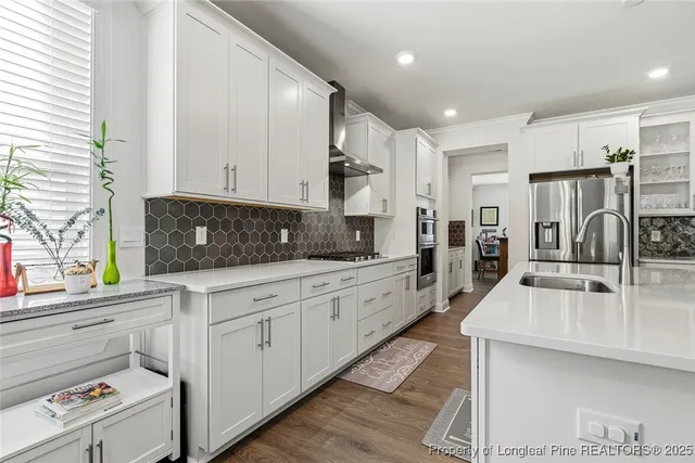 a living room with furniture a fireplace and a large window