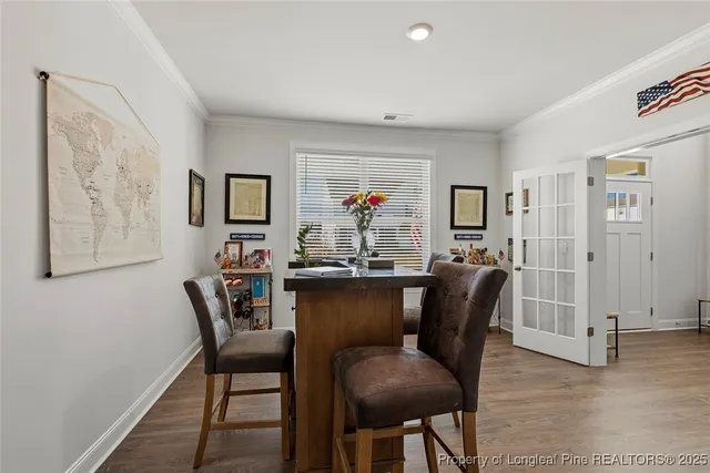 a kitchen with stainless steel appliances granite countertop a stove a sink and white cabinets