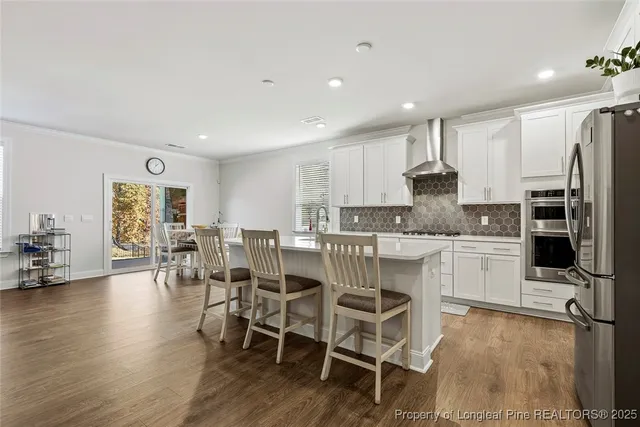 a view of a kitchen with white cabinets