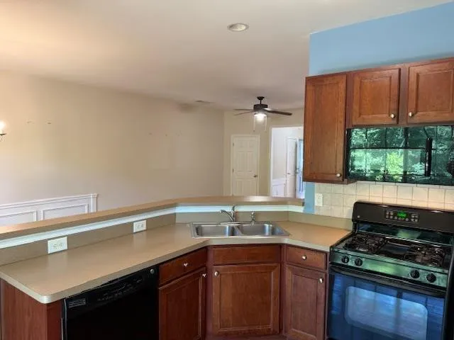 a kitchen with a sink and a stove top oven