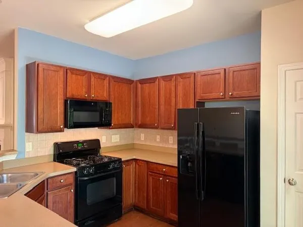 a kitchen with a refrigerator stove and microwave