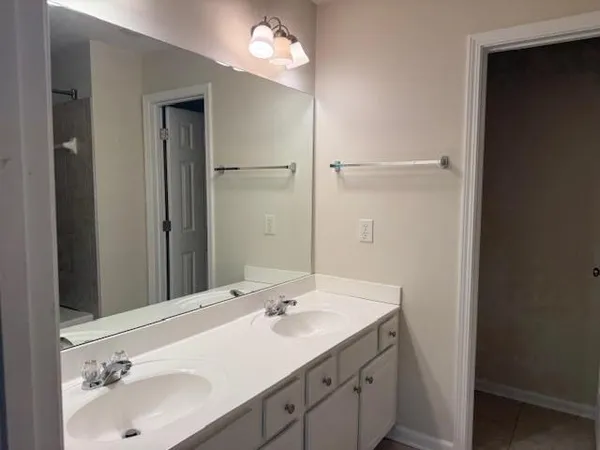 a bathroom with a sink double vanity and a mirror