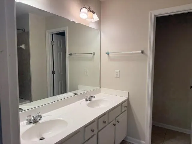a bathroom with a sink double vanity and a mirror