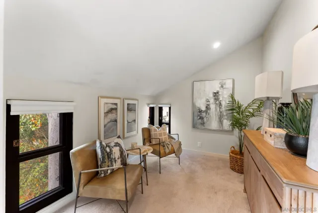 a living room with furniture and a potted plant