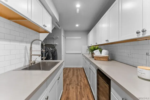 a kitchen with stainless steel appliances a sink a stove and cabinets