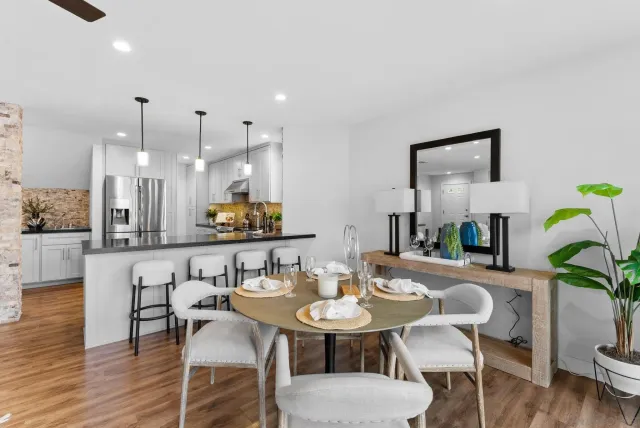 a view of a dining room with furniture and wooden floor