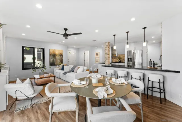 a dining room with furniture a rug and a chandelier