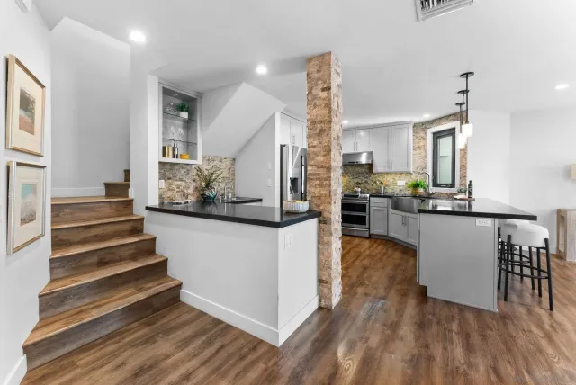 a view of kitchen with furniture and wooden floor