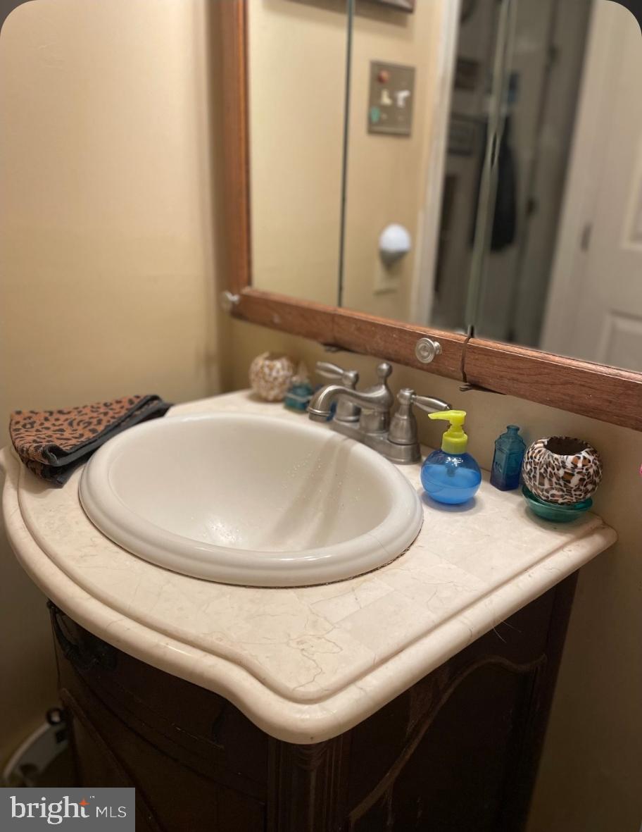 1302 Clover Valley Way, Unit 1302C Edgewood, MD 21040 - Photo 20 of 25 a bathroom with a sink and a mirror