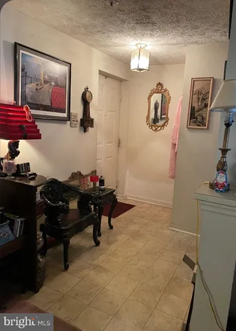 a living room with furniture and wall paintings